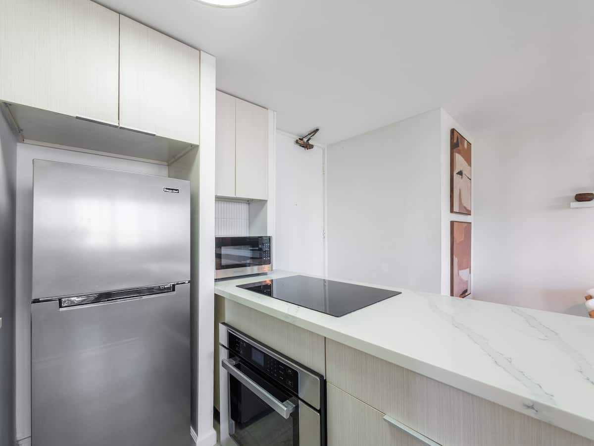 Kitchen counter with refrigerator and oven
