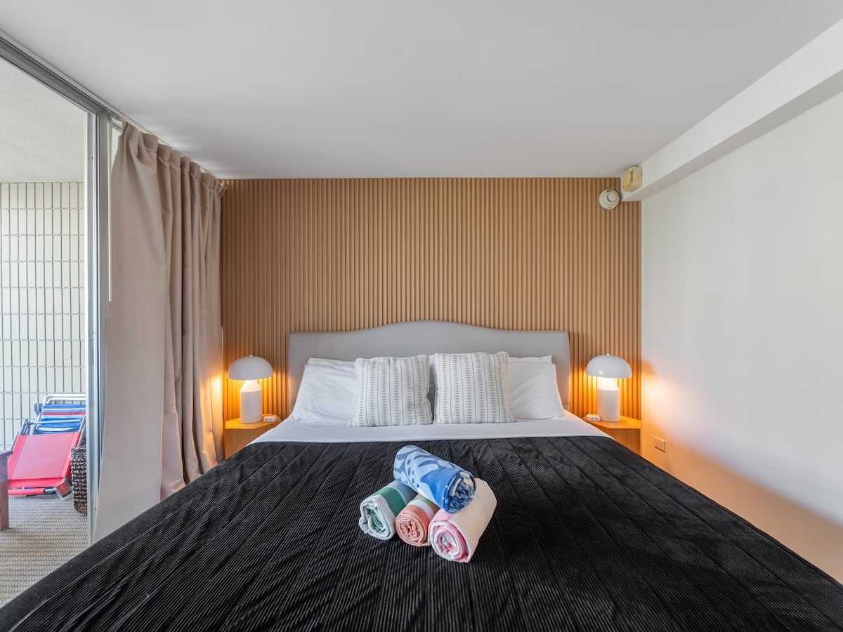 King bed with reading lamps in the private bedroom