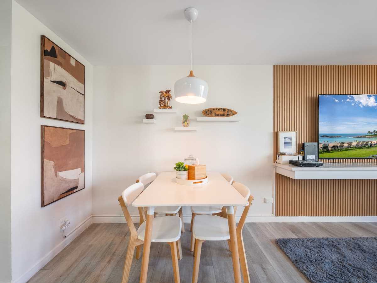 Dining area with framed art and open living room