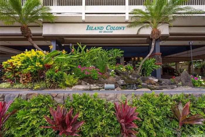 Island Colony entrance sign above tropical landscaping