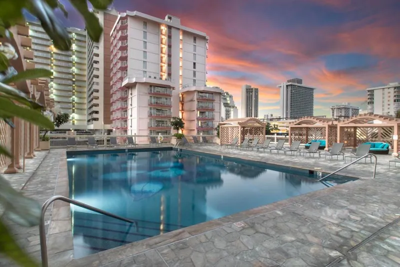 Island Colony swimming pool and cabanas at sunset