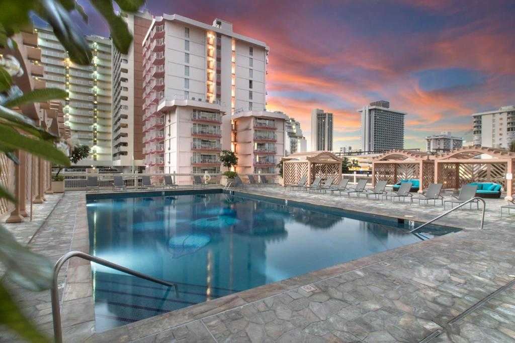Island Colony swimming pool and cabanas at sunset