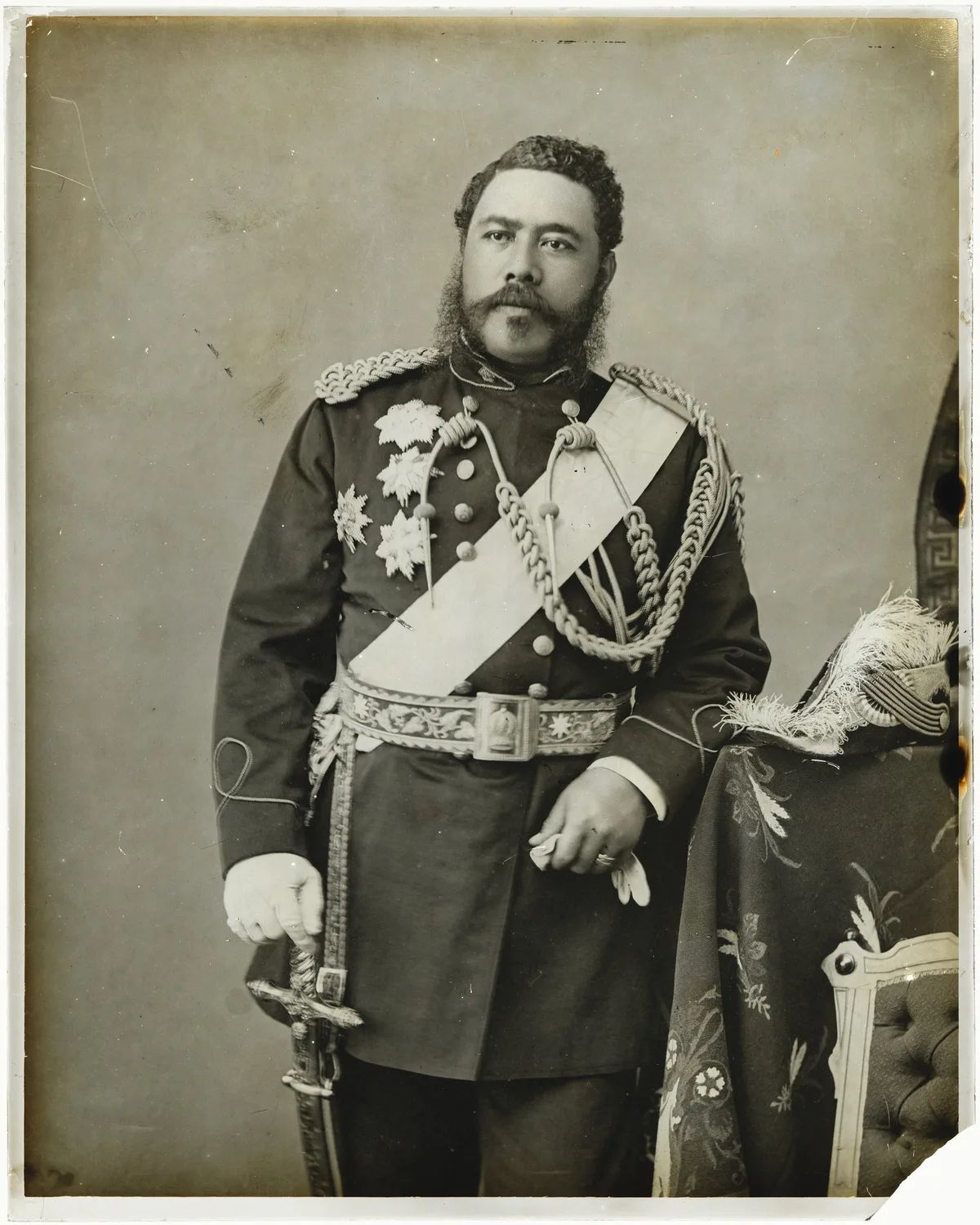 King Kalākaua standing in a decorated formal uniform.