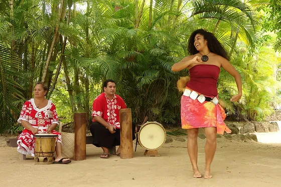 A Tahitian dancer and drummers at the Polynesian Cultural Center.